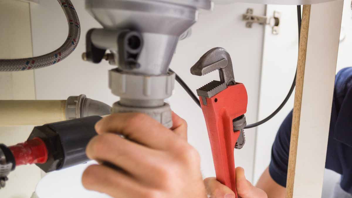 Plumber fixing sink