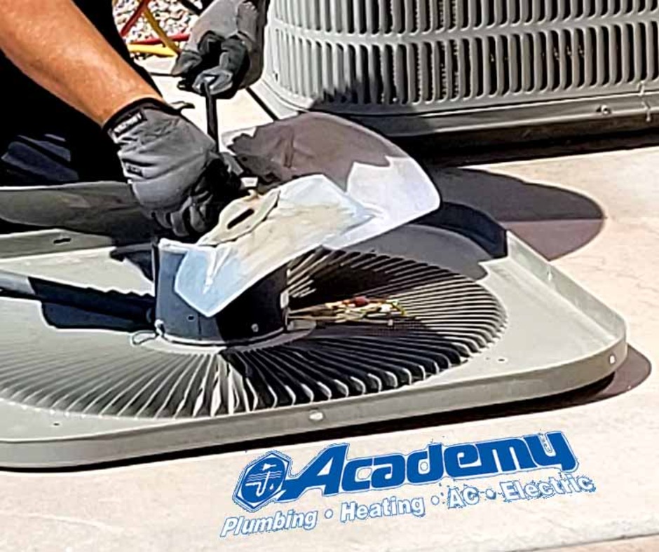 Academy Plumbing technician repairing an air conditioner condenser fan in Albuquerque